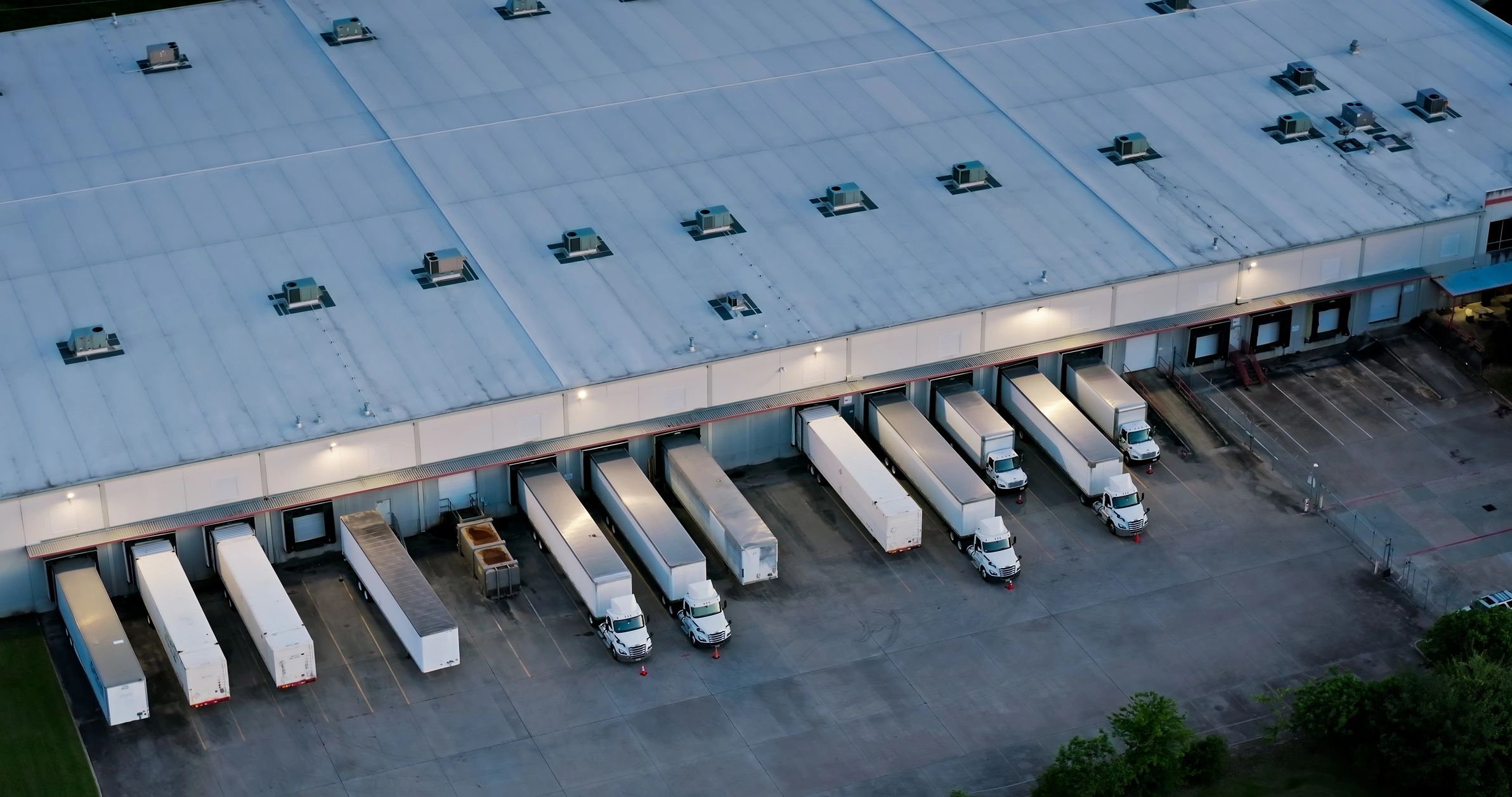 Warehouse with trucks parked at loading docks.