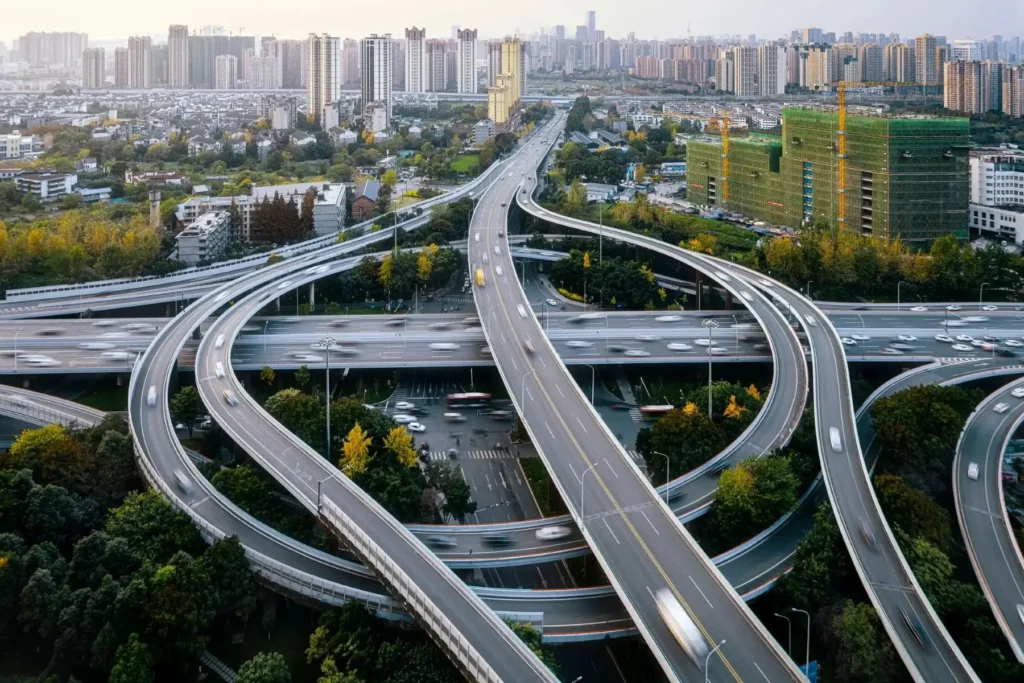 A sprawling urban highway interchange with multiple overpasses and vehicles.